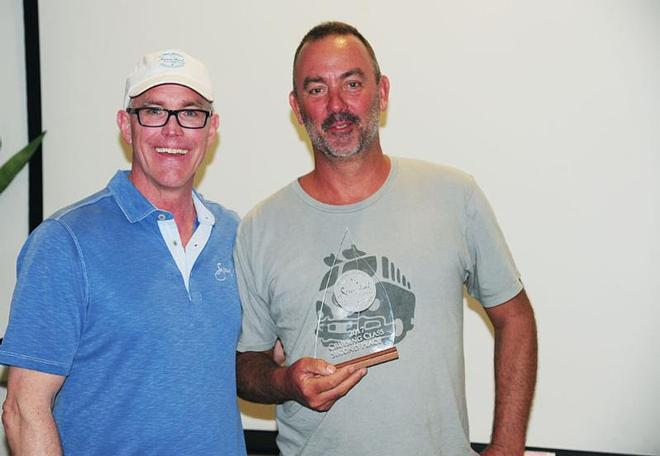 Norwood Smith, Vice President, Sales and Marketing, Scrub Island Resort, Spa and Marina presents Matt Barker's classic yacht, The Blue Peter with a beautiful trophy for second in CSA cruising – BVI Spring Regatta and Sailing Festival © Todd VanSickle